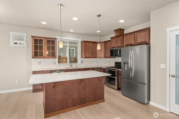 Quartz counters throughout the home. Look at that awesome island, perfect for prepping and entertaining