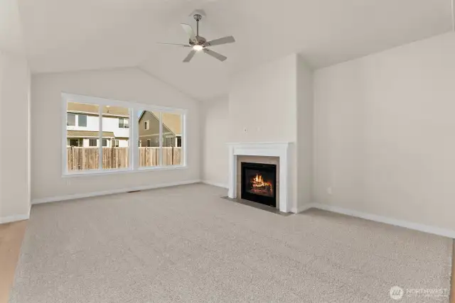 great room with vaulted ceilings, gas fireplace and ceiling fan