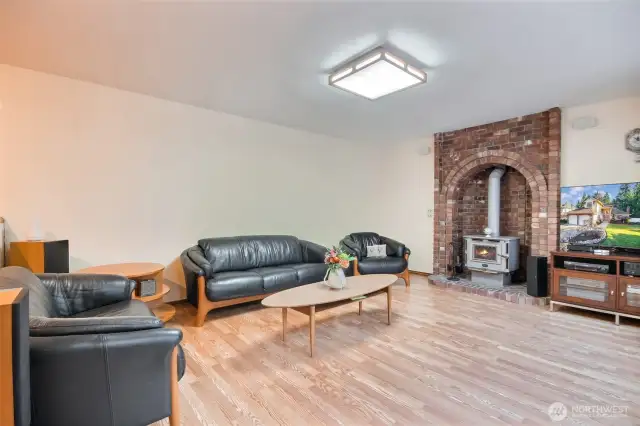 Cozy family room has wood stove and heated floorings