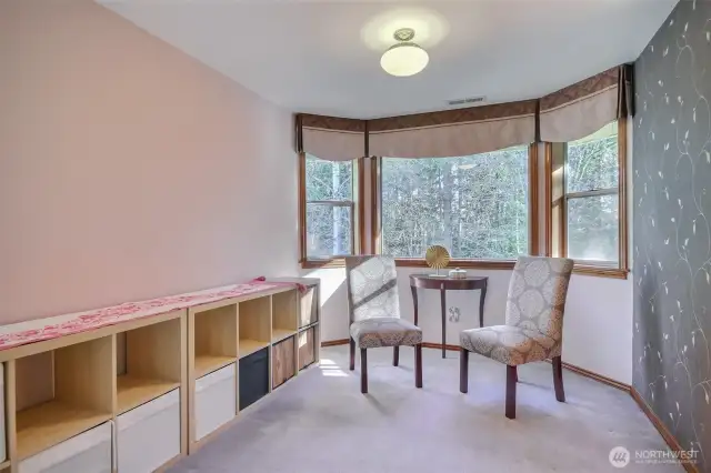 Primary suite has sitting area to look out beautiful backyard and greenbelt