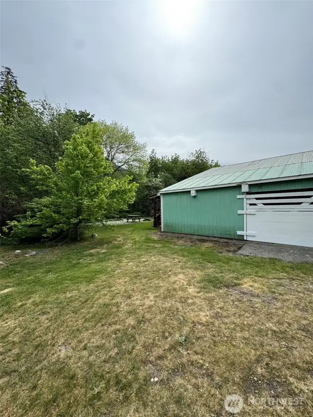Large sliding door access to side of shop. Lots of space for riding lawnmower, atv, etc