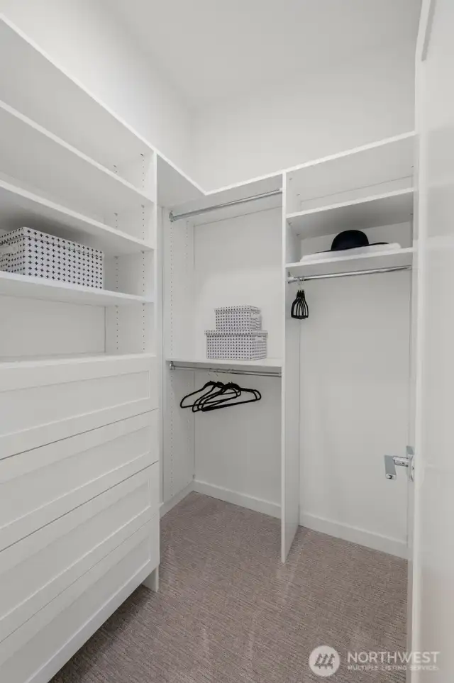 Storage meets style in your custom walk-in closet, designed with function and flair.