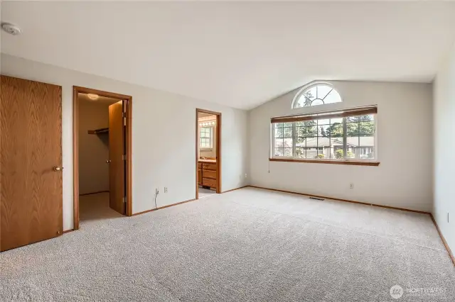 Primary bedroom with vaulted celings.