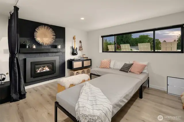 Lower level open media/rec room with gas fireplace and remote control shades. Perfect for a game room.