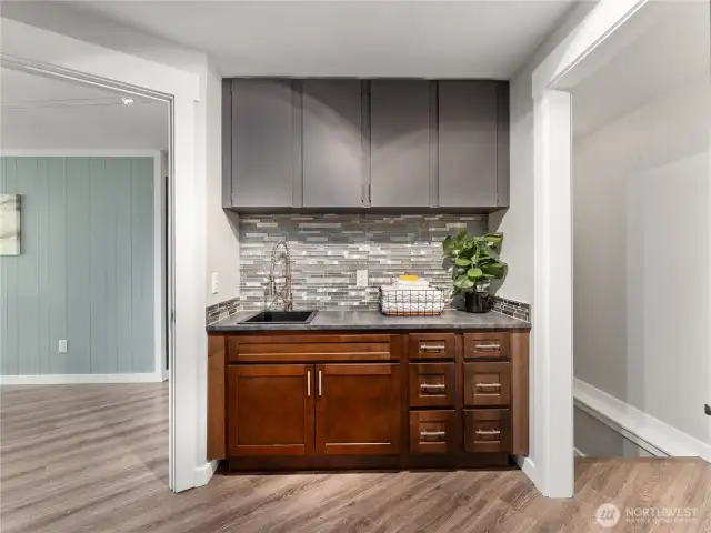 Laundry room features an elegant sink area and built-in storage for added functionality.