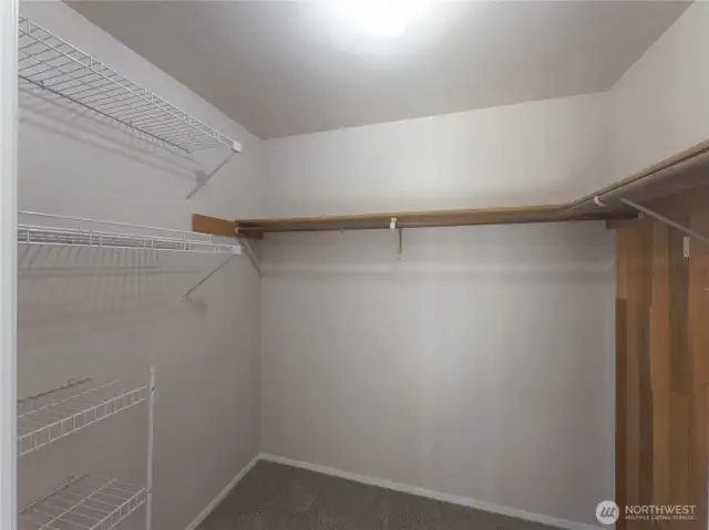 Large walk in closet with shelving.