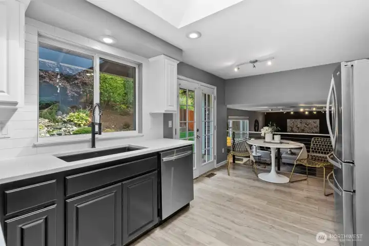Excellent flow, the kitchen seamlessly connects to the family room and looks out onto pretty backyard.
