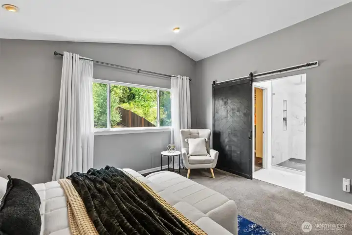 Chic barn door opens to a beautiful ensuite bathroom and walk-in closet.