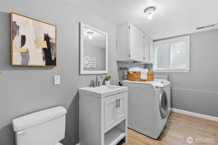 Laundry room with sink and half bathroom.