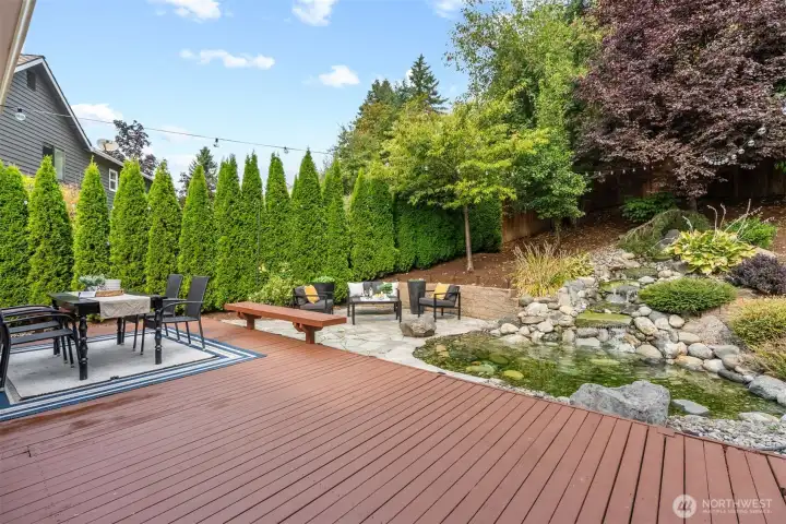 Beautiful deck and patio with pretty ornamental pond and water feature.
