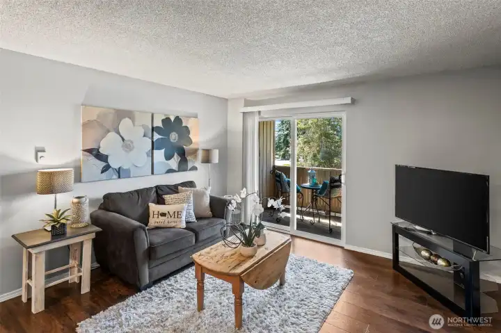 Living room with sliders out to the outdoor deck.
