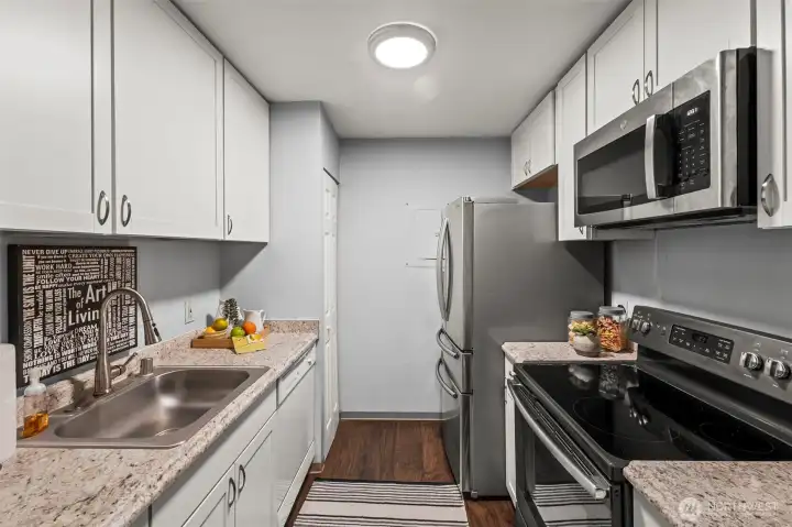 Stainless steel appliances and white cabinets combine for a modern look.