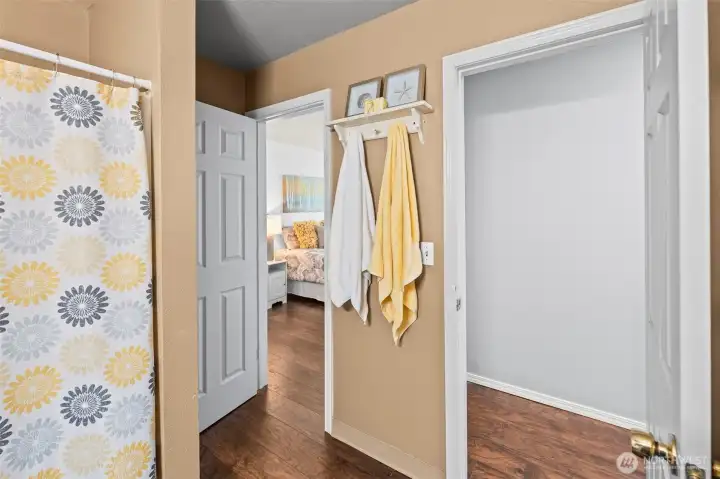 Bathroom is accessed by both hallway and primary bedroom