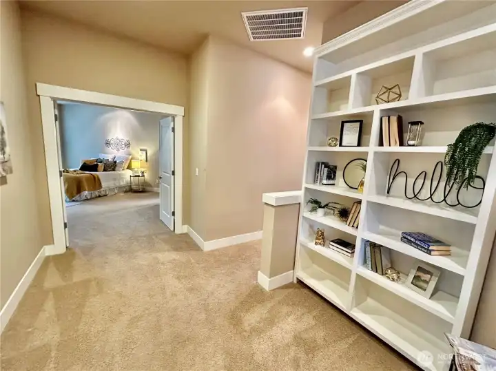 View from office nook in hallway toward double door entry to primary suite.