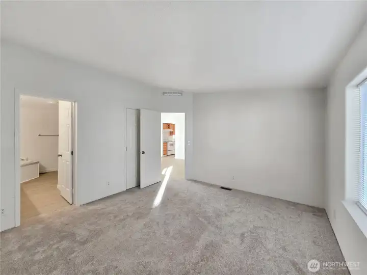 Primary suite with a large walk-in closet and private bath including a dual sink vanity and relaxing corner soaking tub—your own peaceful retreat.