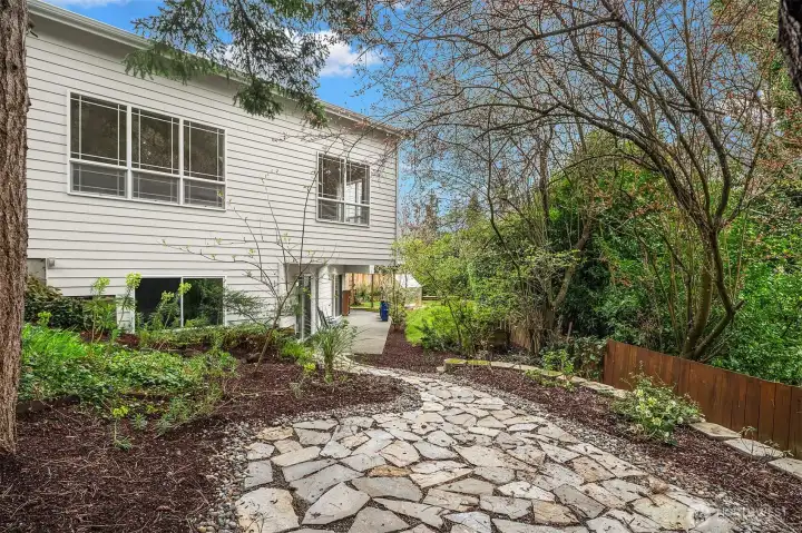 a paved path leading to the flagstone patio