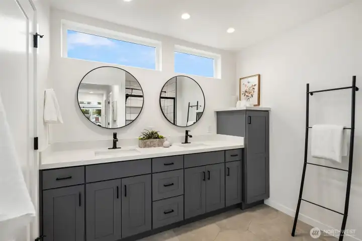 Primary suite bath with double sink, WC for toilet, extra built in cabinets for added storage, and a spa-like walk-in shower.