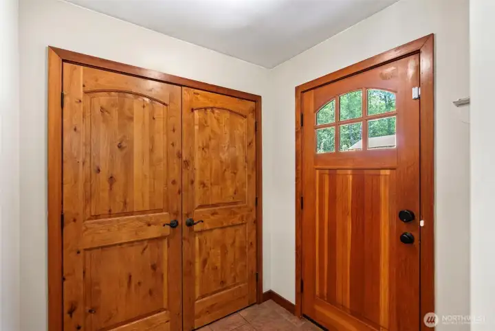 Entryway showcases a solid fir from door and introduces you to pine doors found throughout the home.