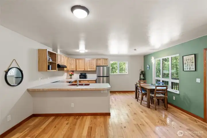 Kitchen is well-positioned with several eating areas and naturally leads to both the great room and outdoor covered porch and fully-fenced back yard.