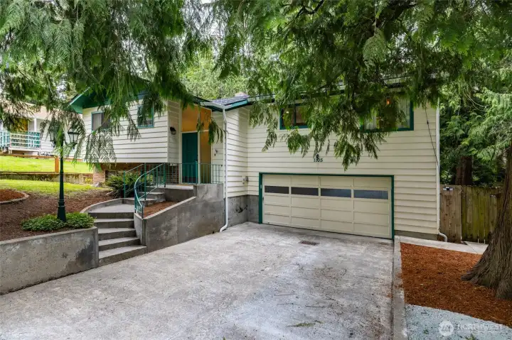 Thoughtfully updated mid-century split-entry home with spacious driveway leading to two-car garage