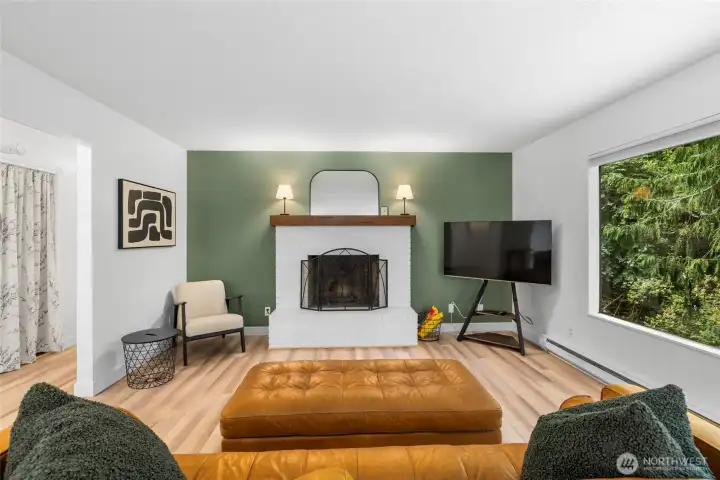 Beautiful white brick wood-burning fireplace anchors the room