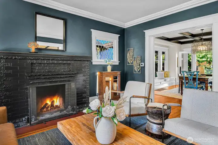 Grand pocket doors slide open to create flow between living and dining rooms. Grand pocket doors slide open to create flow between living and dining rooms.