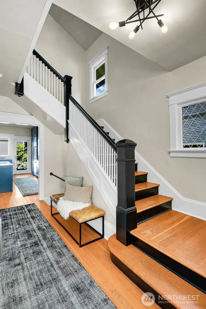Original millwork and modern lighting lead to the second floor. Original millwork and modern lighting lead to the second floor.