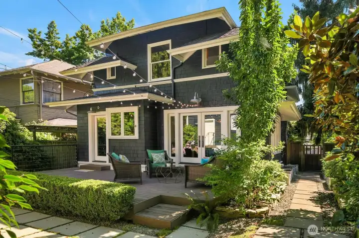 A view of this grand home from the backyard. Those are raised planters along the right side walkway. A view of this grand home from the backyard. Those are raised planters along the right side walkway.