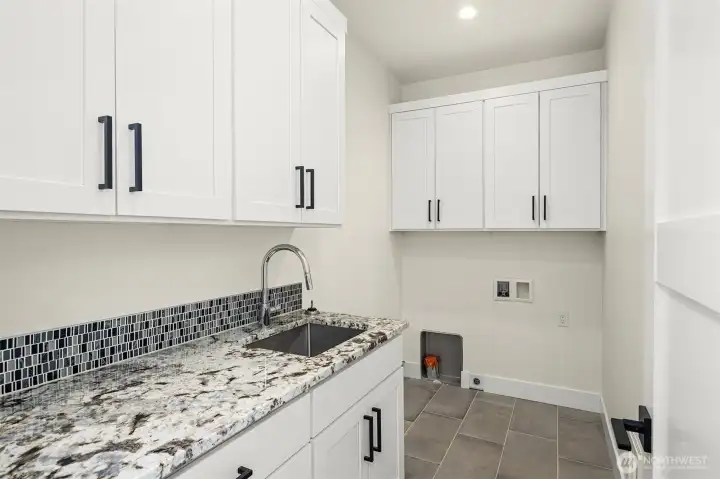 Spacious second flor laundry room loaded with cabinets and lovely granite counters Spacious second flor laundry room loaded with cabinets and lovely granite counters