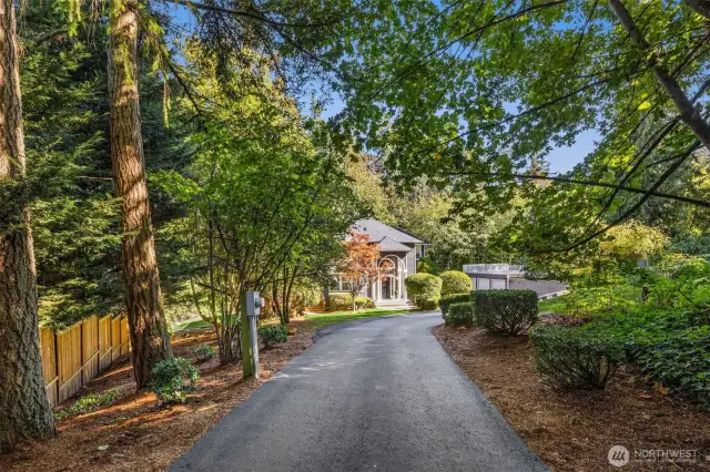 Set on a level and usable acre, the private driveway leads you to an expansive 4,360 sq. ft. home