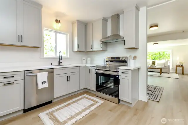 Kitchen w/stainless brand new appliances and quartz countertops.