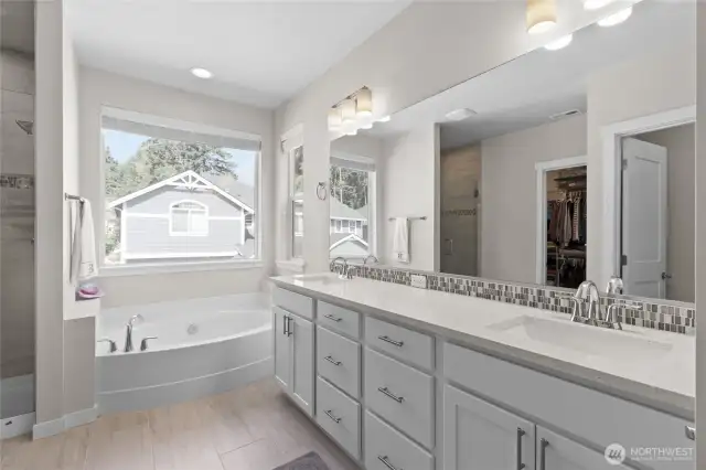 Spacious Primary bath w/dual vanities, separate bath shower and walk-in-closet