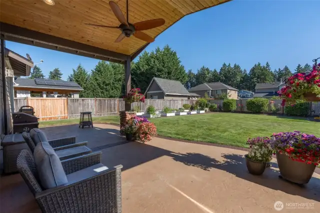 Relax under the covered back patio. The ceiling fan provides a little breeze