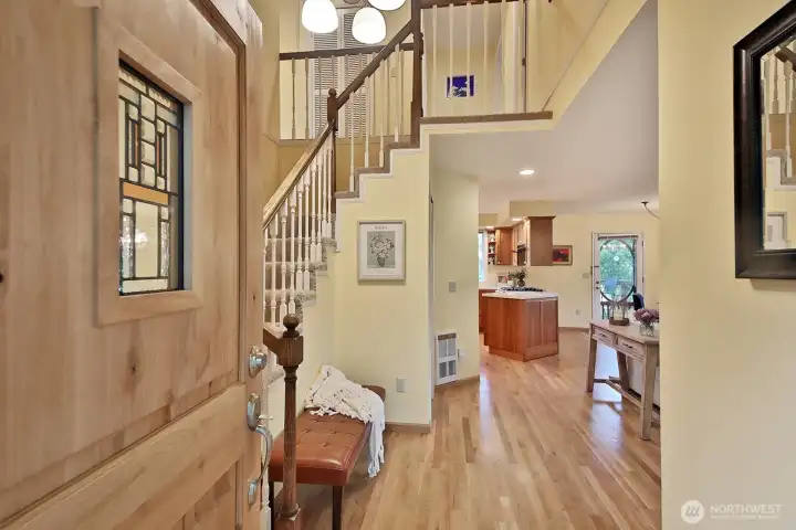 Hardwood floors and vaulted ceiling entry welcome you. Stairs to the left lead to the Primary Suite, 3 additional bedrooms, an office & a flex room. There is also a small bedroom and 3/4 bath on this main level.
