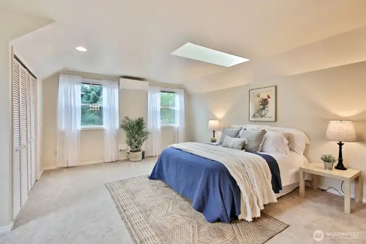 Spacious Primary Suite with two standard sized closets, skylights and mini-split. This room is above the garage and is located on the south side of the home.