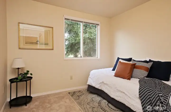 This is bedroom #5 which is located adjacent to the Primary Suite. It looks out upon the western side (back yard) of the home.