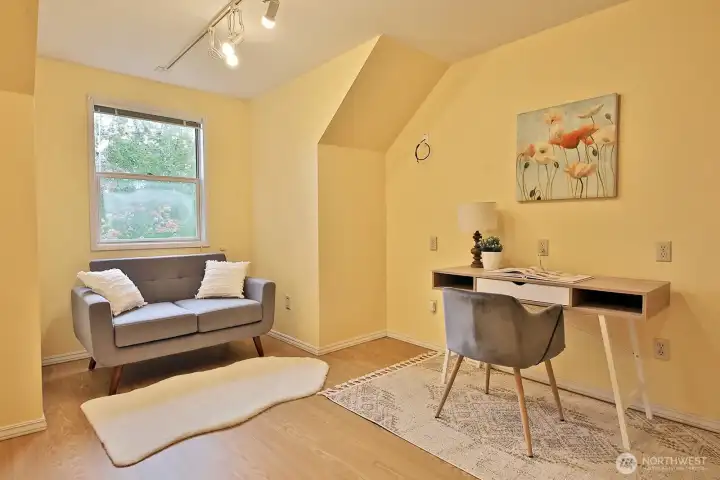 This is a flex space adjacent to the Primary Suite and Bedroom #5. The window looks out to the east side (Gleason Lane) of the home. Floors here are laminate. The rest of the upper level is wall to wall carpet.