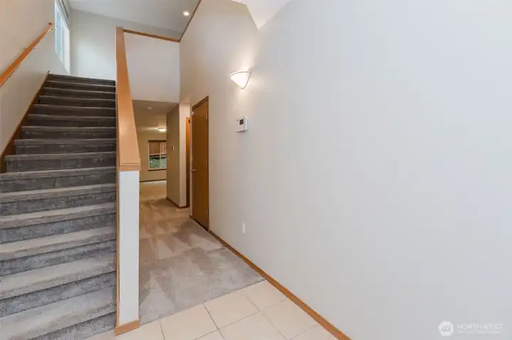 Staircase view from the foyer with natural light.