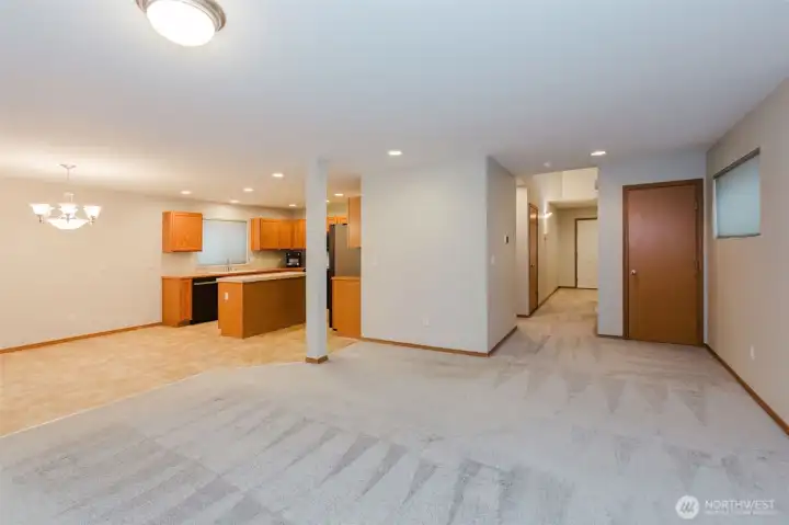 Open concept main level with sightlines to dining and living spaces.