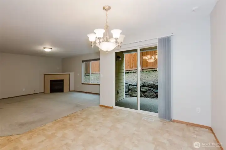 Dining area with chandelier and access to the backyard.