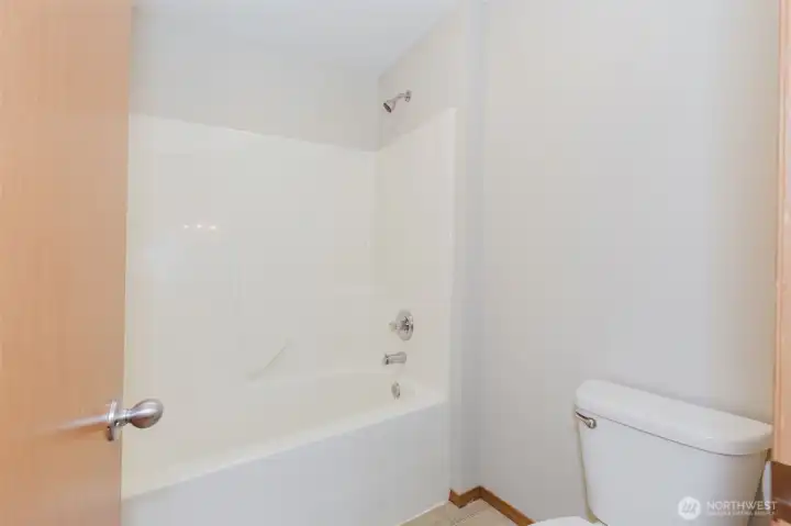 Full bath with tub/shower combo.