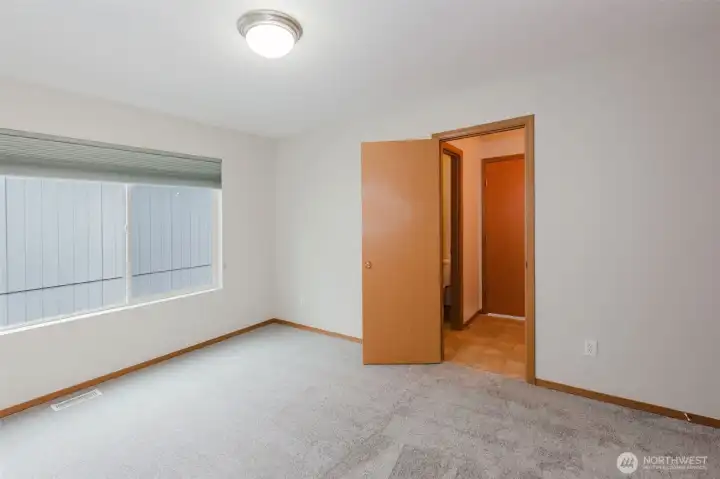 Upper-level bedroom with oversized window.