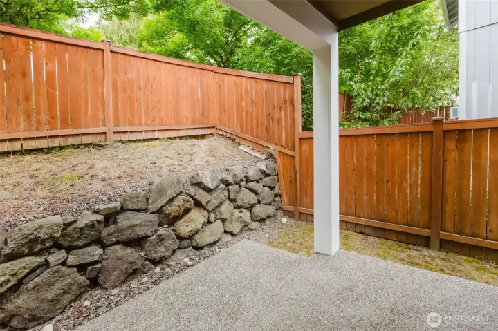 Private backyard patio with rock wall detail.