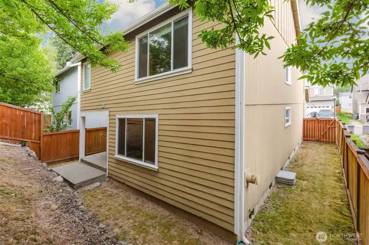Rear exterior of home with fenced yard.