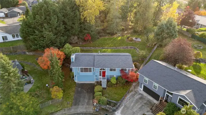 Aerial view of home and woods behind