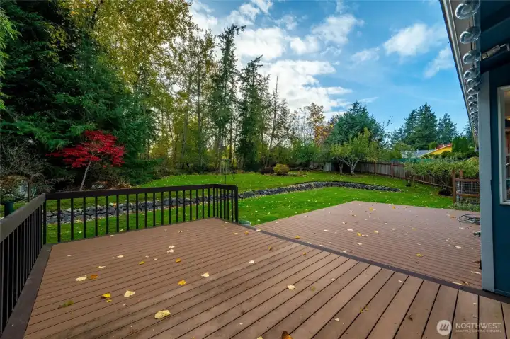 Expansive composite deck in private, terraced backyard w/fenced garden space