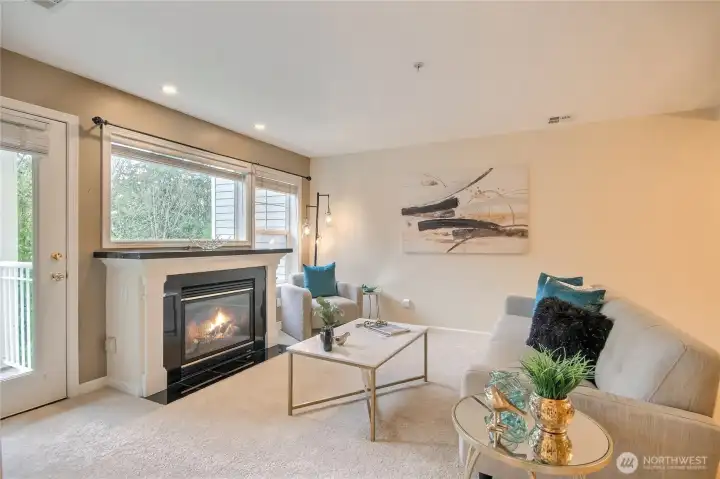 Elegant gas fireplace with windows and door to your territorial views.