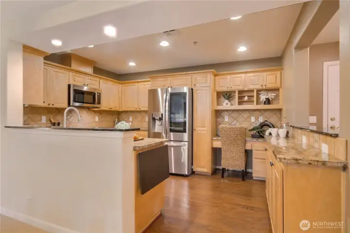 Upgraded kitchen features newer granite, LVP flooring, & SS upgraded appliances.