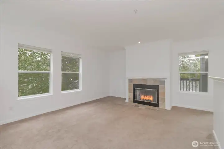 Spacious living area featuring a warm and cozy fireplace.
