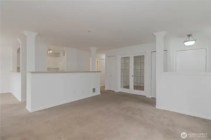 Living area with open sightlines to the den/office and kitchen.
